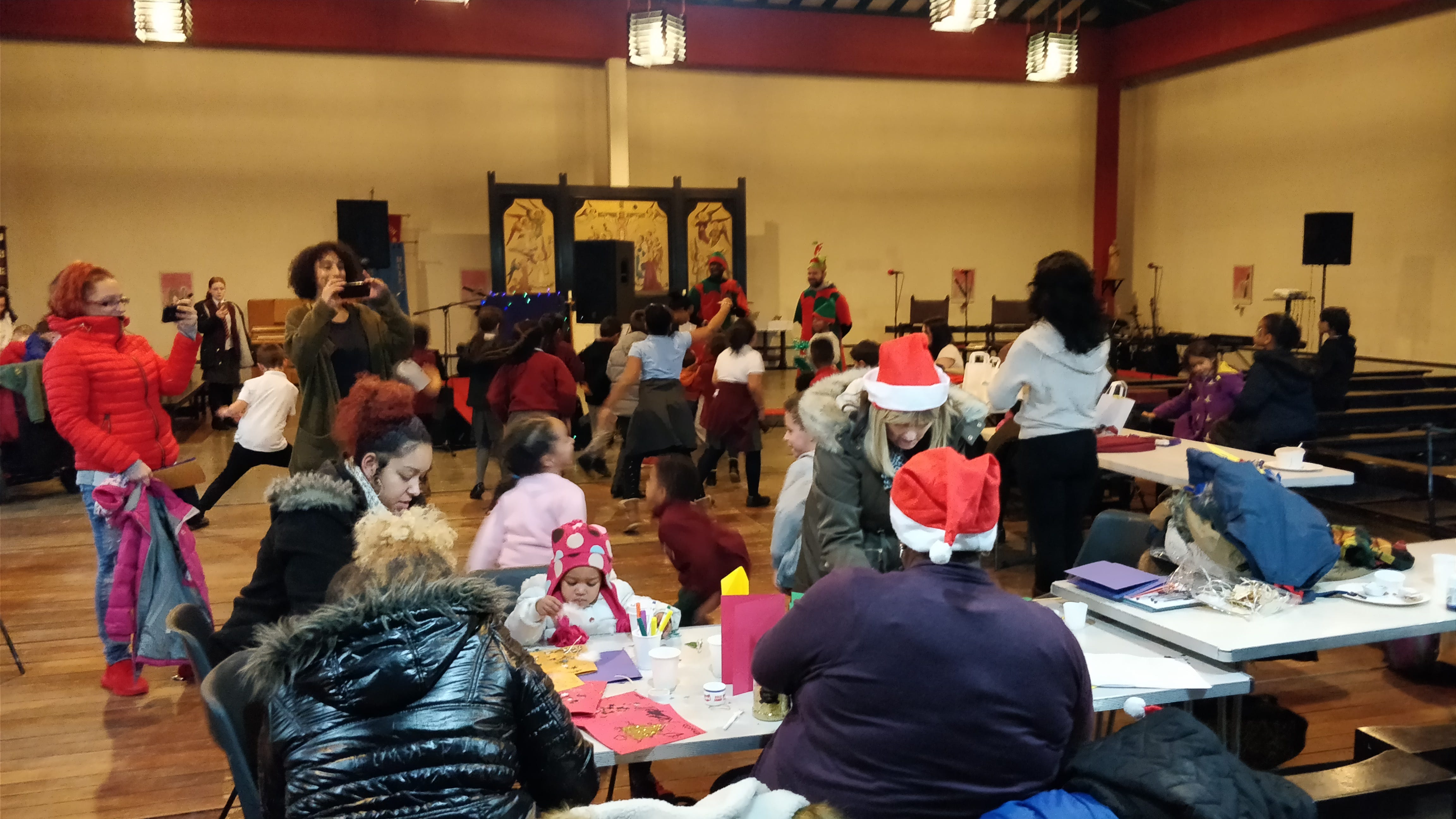 a community space filled with children doing craft activities and dancing